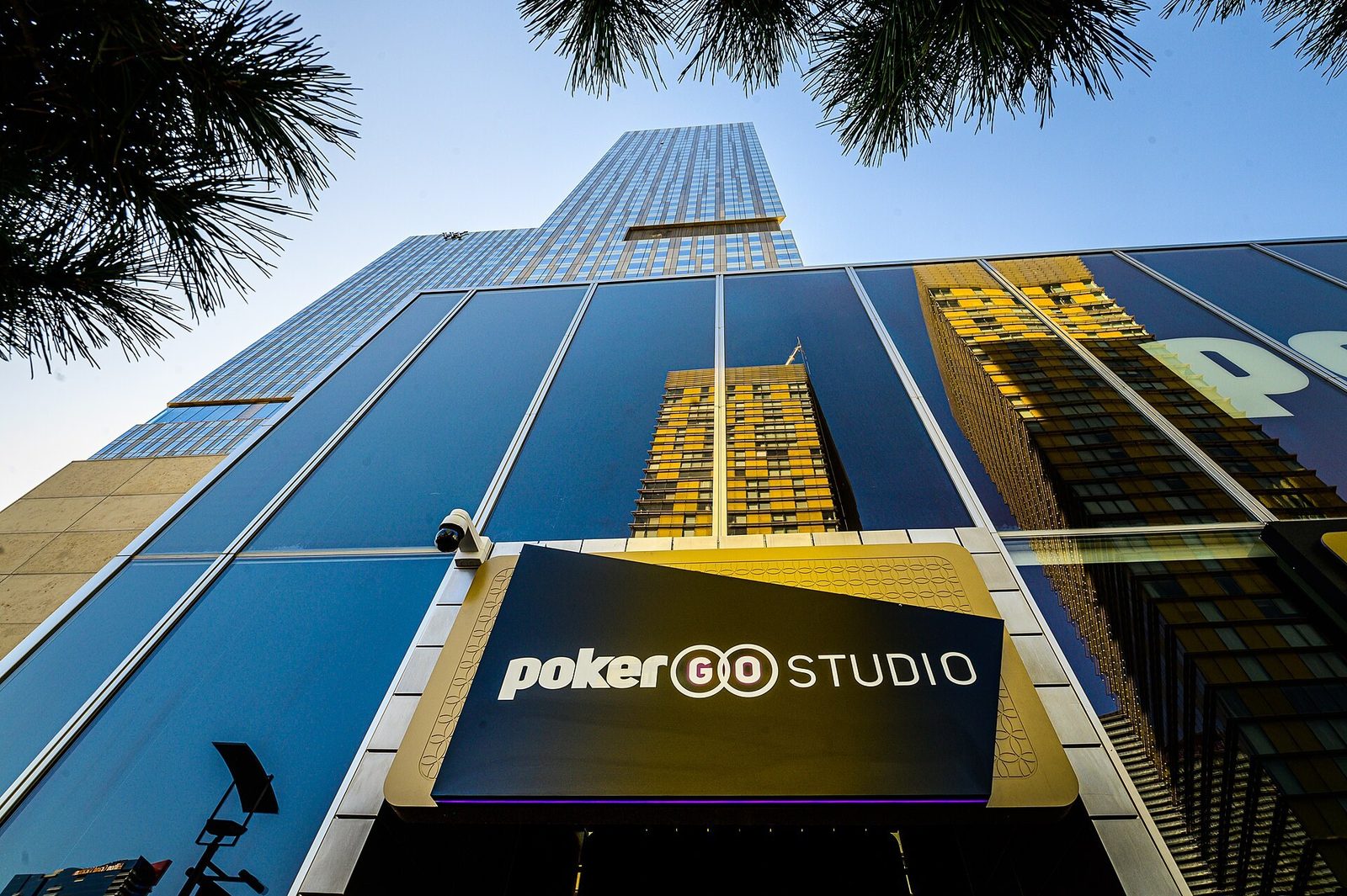 Fachada del PokerGO Studio, en el complejo ARIA de Las Vegas, vista desde abajo con palmeras en primer plano